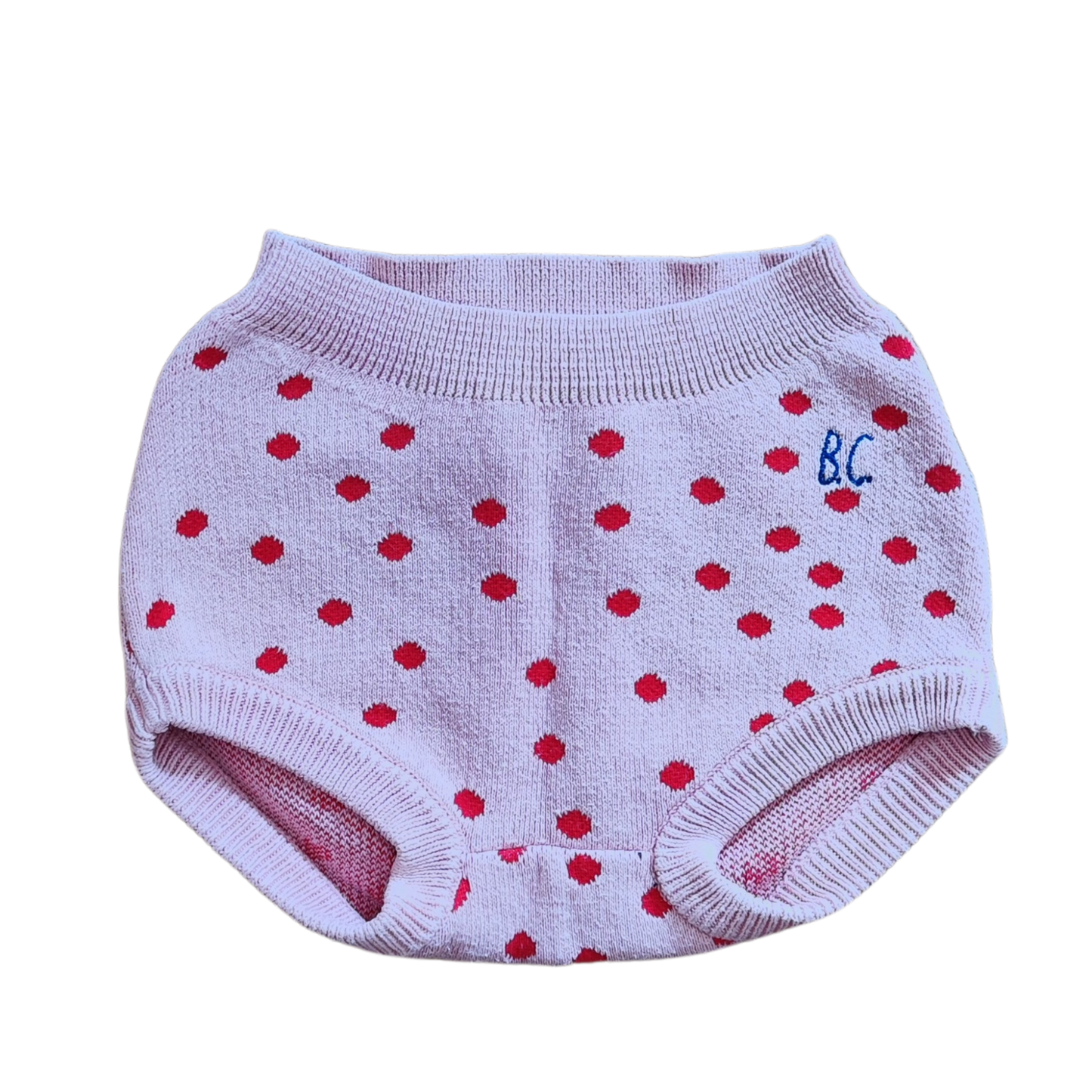 Pre-loved pink knitted culotte with red dots from the brand Bobo Choses. Made of 70% organic cotton 30% polyamide, with elasticated waistband.